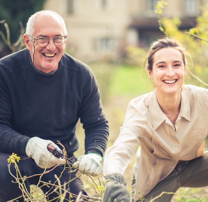 Lauriane Guignon et son père, souriant en taillant des plantes au jardin, univers naturel et botanique de Cépages Parfums