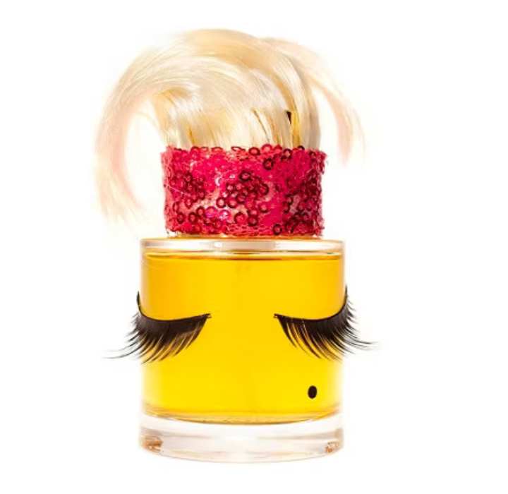 Originele flacon van Jungle Jezebel - Sarah Baker Perfumes. De flacon is versierd met lange wimpers en een dop met blond haar