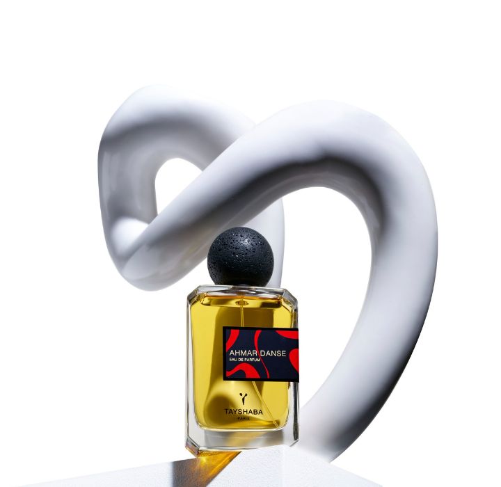 The photo shows a perfume bottle with the label