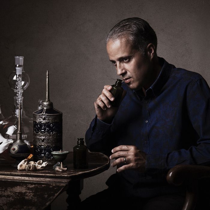 Philippe Constantin, foundeur of niche perfume brand MAISON INCENS, is smelling ingredients, surrounded by arabic objects